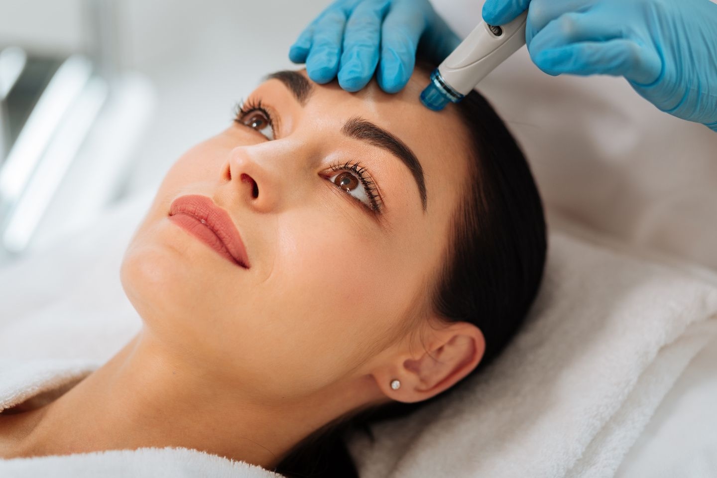 Woman getting hydrafacial treatment