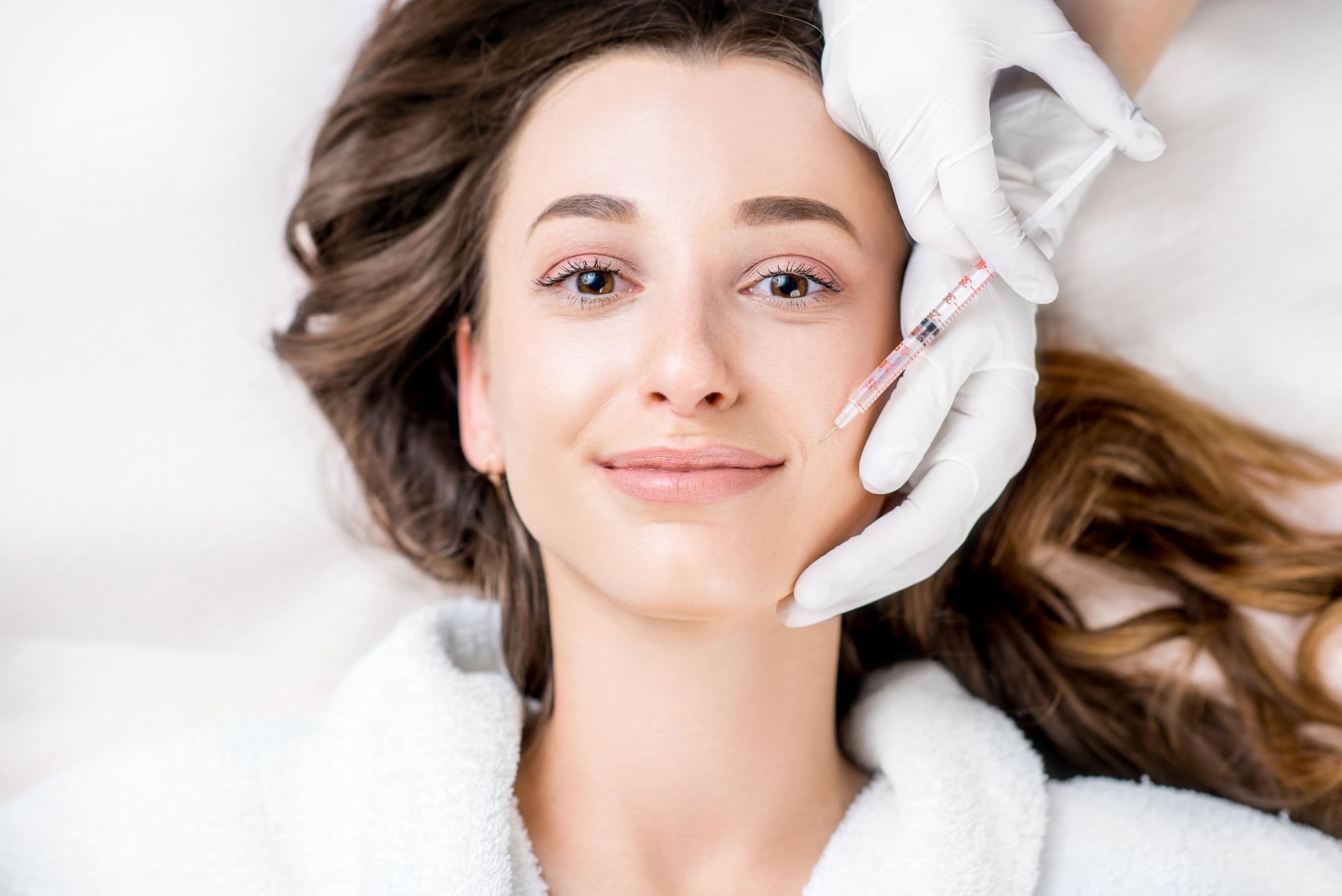 Woman getting anti wrinkle injections, smiling
